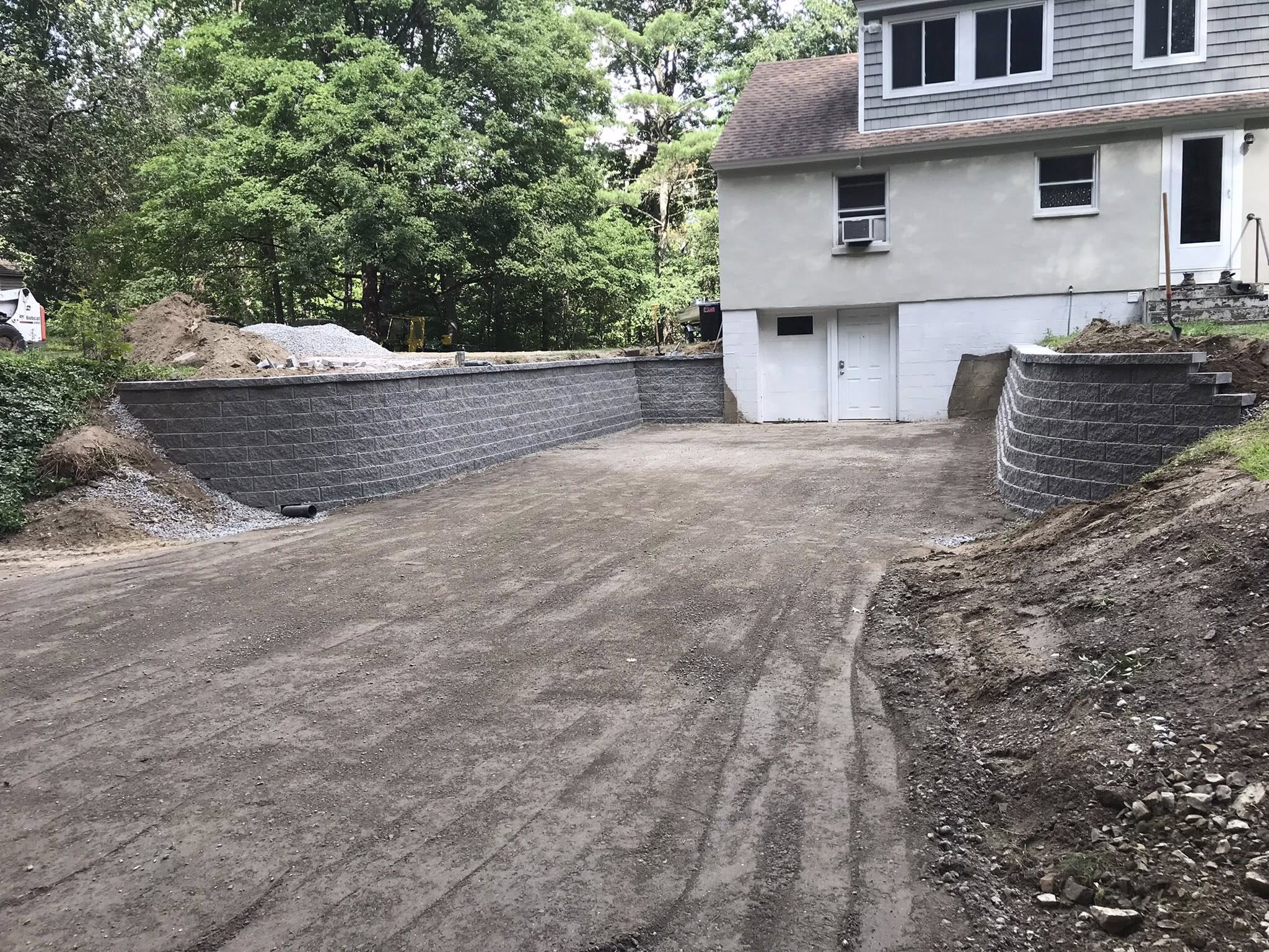 Completed block retaining wall with graded parking area